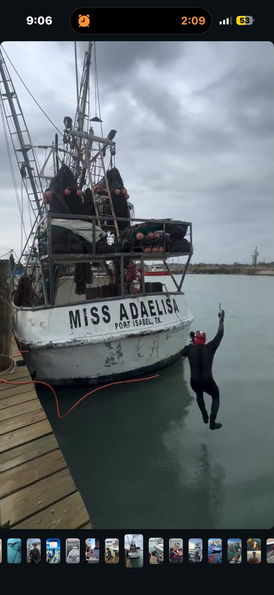 A diver enters the water beside the fishing boat Miss Adaelisa in Port Isabel, Texas.